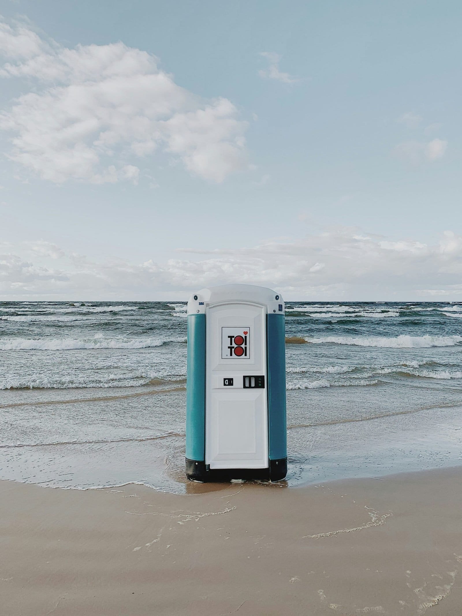 white and blue booth on seashore